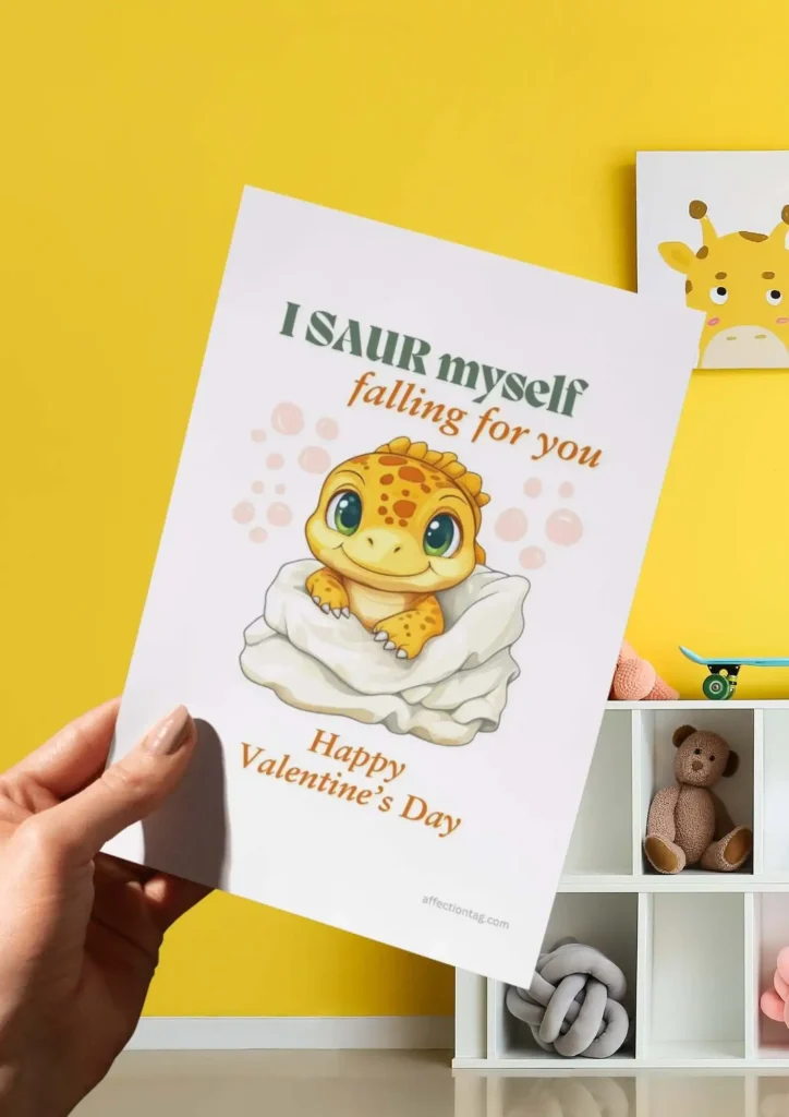 A lovable Dinosaur Valentine card showcasing a baby dinosaur nestled in a blanket, captioned "I SAUR myself falling for you. Happy Valentine's Day." ©affectiontag.com